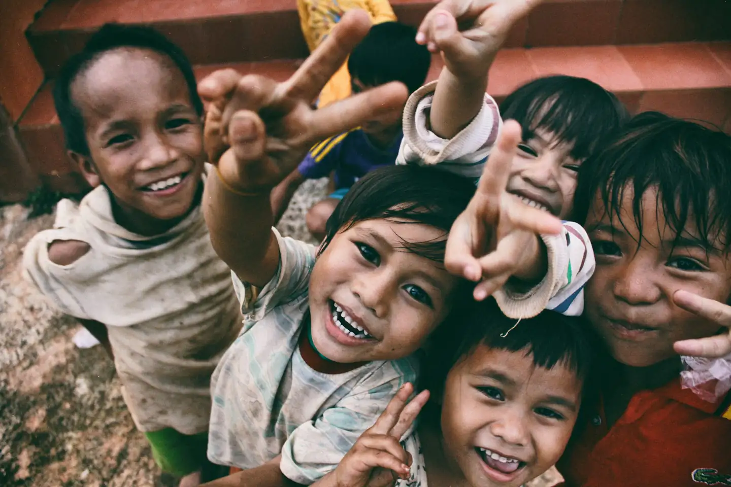 Children smiling in a community supported by climate resilience work