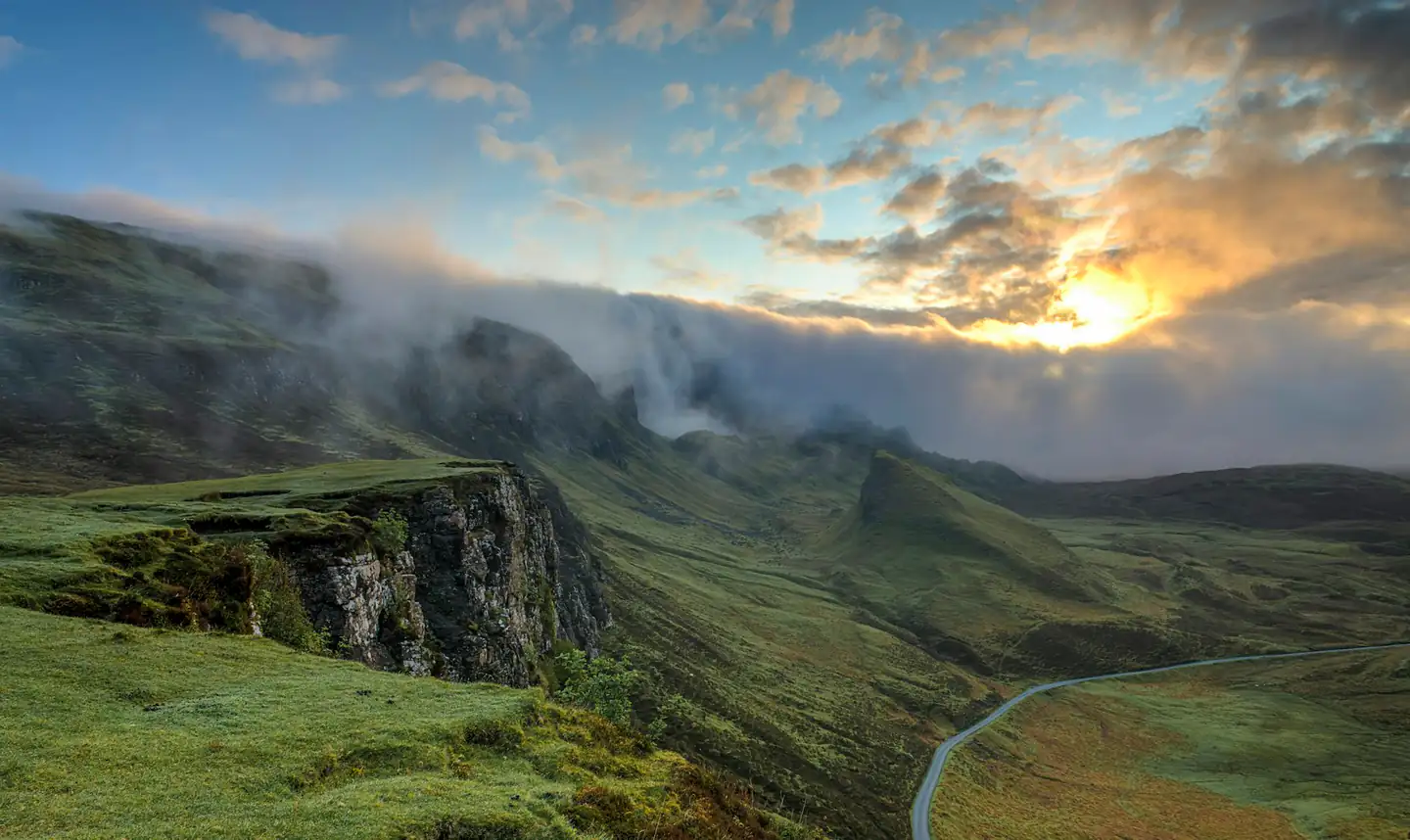 Misty green highlands at dawn